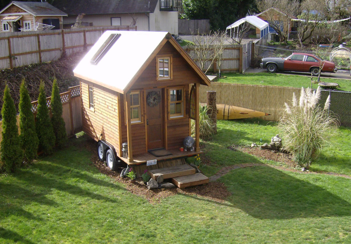 Dee Williams' Kozy Kabin Tiny House parked in a yard. How to find tiny house parking.